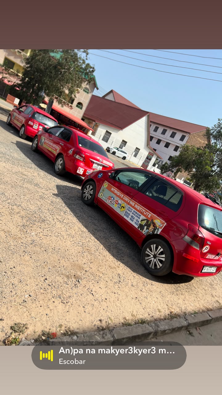 Line of three red training cars with roof L-signs