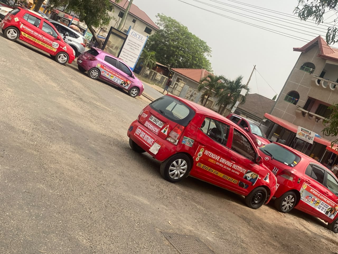 Full fleet of Intensive Driving Institute training vehicles parked at Weija