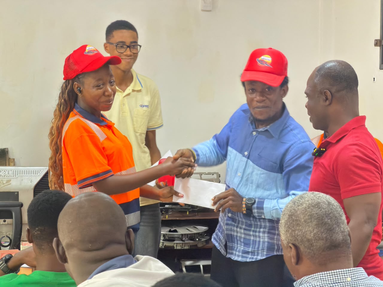 Graduation award presentation in classroom with red Intensive caps