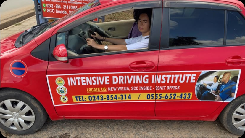 Student receiving hands-on dual-control steering instruction at Intensive Driving Institute