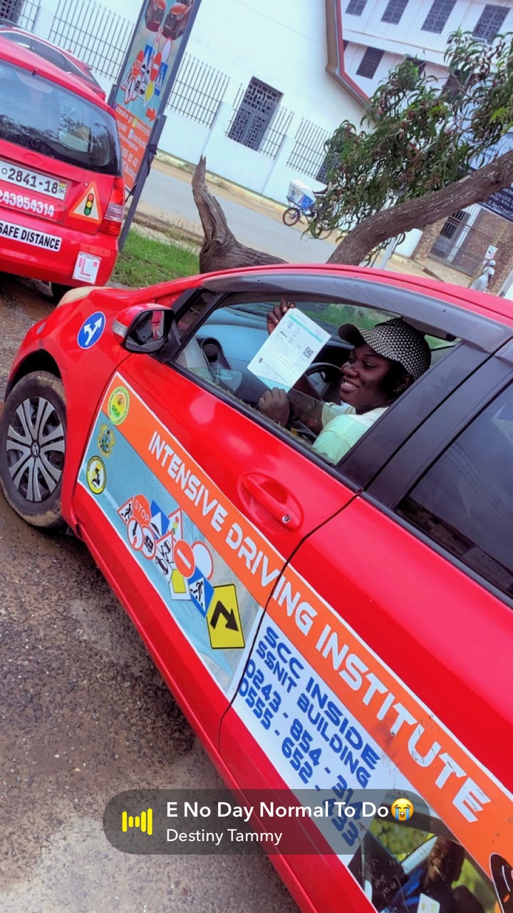 Student inside training car displaying official DVLA pass results